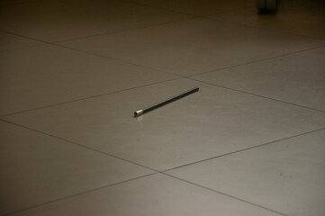 Fototapeta na wymiar A black pencil on the floor.