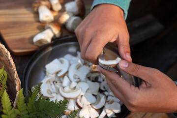 Man slicing mushrooms at table, closeup view