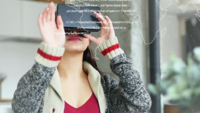 Animation of world map with data processing over woman using vr headset