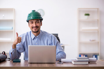 Young male architect working in the office