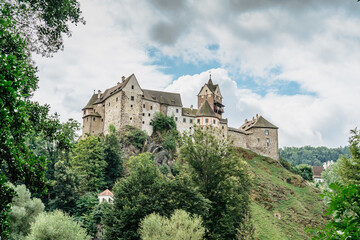 Fototapeta premium Panoramic view of famous medieval town of Loket,Elbogen, with colorful houses and stone castle above river,Czech Republic.Historical city centre is national monument.Travel architecture background