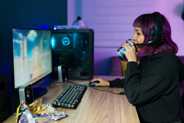 Profile of a young woman drinking an energy drink