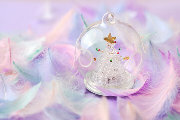 glass Christmas decoration ball against purple background