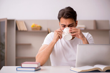 Young male student studying at home during pandemic