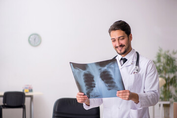 Young male doctor radiologist sitting in the clinic