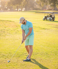 male golf player on professional course with green grass sunny weather, sports