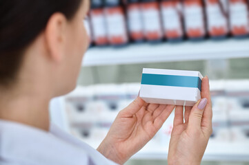 Medicine in hands of female pharmacist