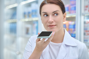 Woman holding smartphone at face level