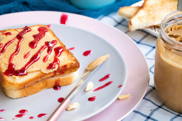 Breakfast on a plate. Toast with peanut butter and berry jam. Toaster bread. fresh sandwich for breakfast. High quality photo