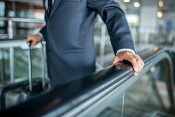 Male hand touching handrail on escalator