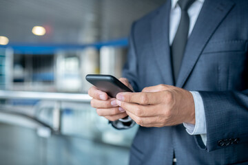 Hands of business man holding smartphone