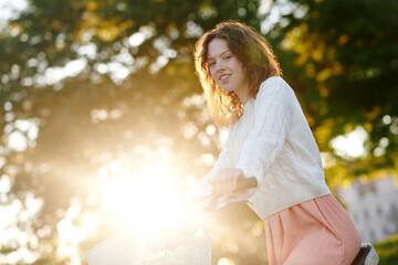 Cute young girl in the park looking dreamy