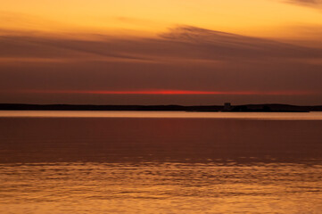 Beautiful sunset on the lake on an autumn evening.