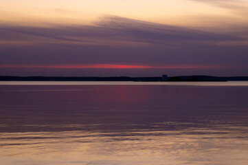 Beautiful sunset on the lake on an autumn evening.