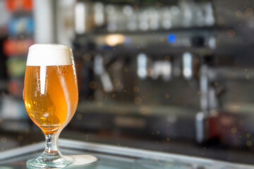 Glass of beer on the bar counter