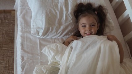 little cute girl is going to go to bed. indulges in, does not want to sleep. naughty. Cute little...