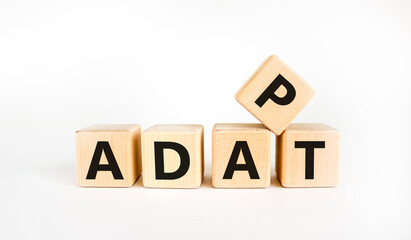 Adapt symbol. The concept word 'adapt' on wooden cubes. Beautiful white table, white background. Business, adaptation and adapt concept. Copy space.