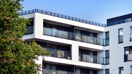 Inspiring view of the modern city. The wall of the apartment building   against trees. Apartment...