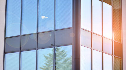 Corporate architecture building. New modern office building. Textured blue pane of contemporary glass architectural building. Sunlight.