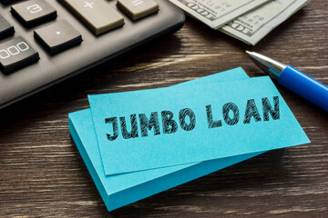 Financial concept about JUMBO LOAN with phrase on the piece of paper.