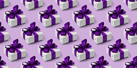 Seamless pattern with cute gifts on purple background. Boxing day.