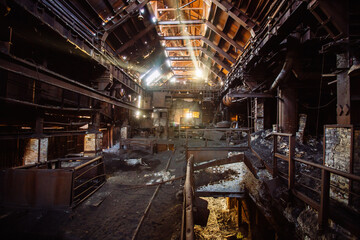 Old rusty abandoned metallurgical plant. Ruined blast furnace