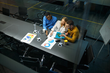 Young managers, conference in IT office, top view