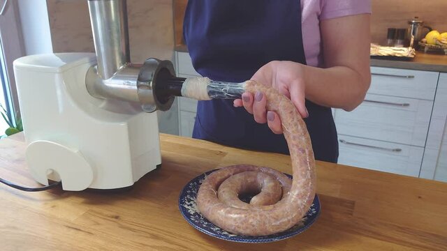 the process of making homemade grilled sausage from minced meat. the cook fills the intestines with minced meat. home food close up