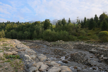 Picturesque view of beautiful river flowing along rocky banks in morning