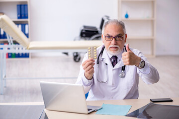 Old male doctor working at the hospital