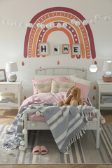 Stylish child's room interior with comfortable bed