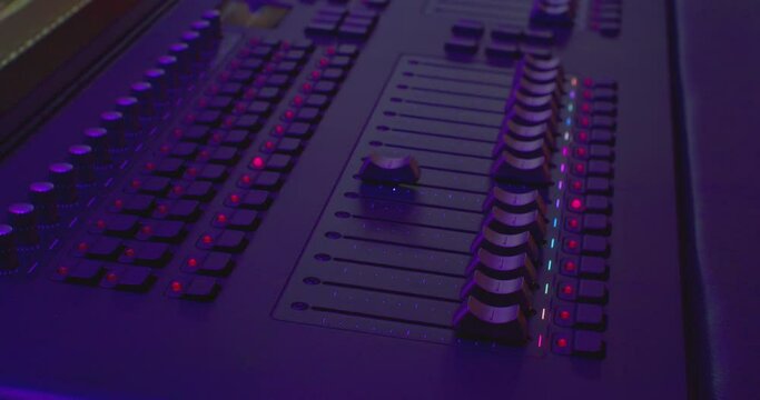 modern electronic console for sound control. equalizers move on the mixer. close-up.
