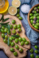 Homemade crushing olive making. Fresh green olives are breaking one by one. Crushing olives with stone. Preparing pickled olives in Turkish style. (Turkish name; kirma zeytin)