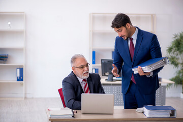 Two male colleagues working in the office