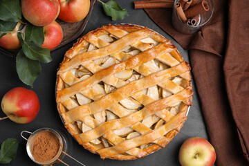 Delicious traditional apple pie on black table, flat lay