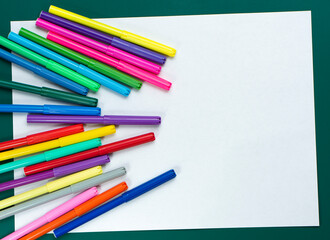 Fototapeta premium A set of felt-tip pens and a sheet of drawing paper with place for text.