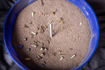 Reloading 9mm brass casing: cleaning and polishing  with tumbler using walnut shell media.