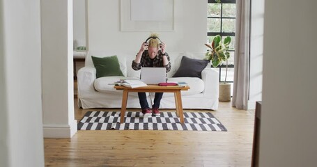 Albino african american man with dreadlocks working and using laptop