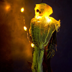 Halloween decoration a skeleton in a white cape decorated with a garland of glowing pumpkins
