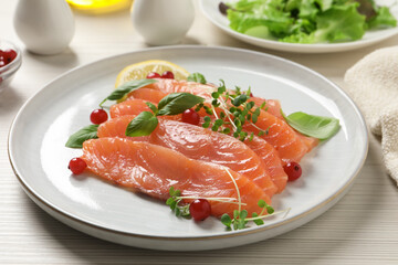 Delicious salmon carpaccio served on white wooden table, closeup