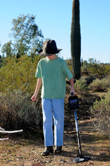 Boy with a metal detector treasure hunting