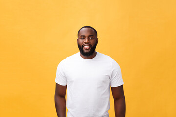 Portrait of a modern young black man smiling standing isolated yellow background