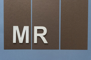 the letters M and R on a paper background