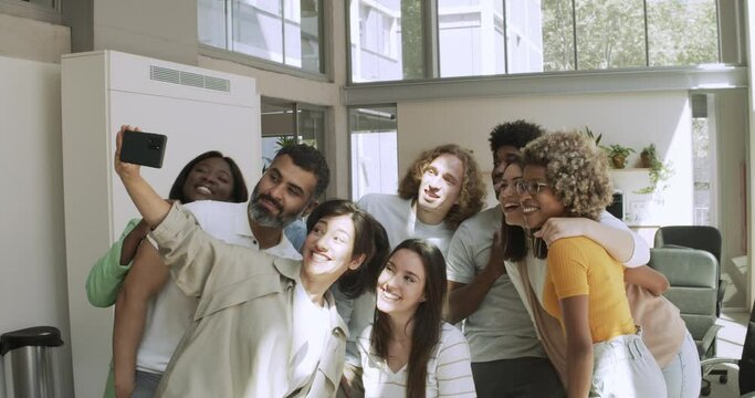 Group of multi-ethnic business workers taking a selfie in the office or coworking. 
