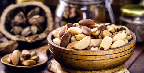 bowl with peeled Brazil nuts on a rustic table. healthy cooking ingredient