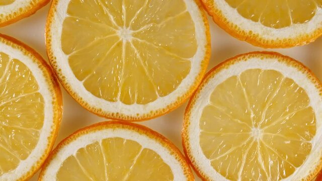 Macro Shot of Sliced Orange Fruit Slices and Rotate. Orange Fruit Pattern. Healthy Food Background. Slow Motion. High quality 4k footage