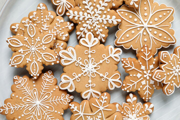 Tasty Christmas cookies on plate, flat lay