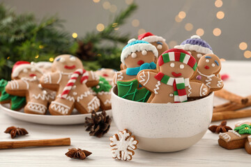 Delicious homemade Christmas cookies on white wooden table against blurred festive lights