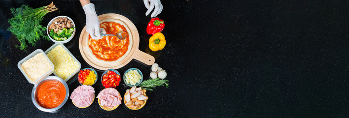 Top view of Chef is spreading tomato sauce on Pizza dough with a metal ladle and Pizza ingredients, spices for cooking pizza's Restaurant or Homemade. Copy space for text. Banner