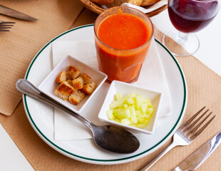 Andalusian gazpacho - vegetable soup puree traditionally served cold with crispy fried croutons and cucumbers. Spanish cuisine